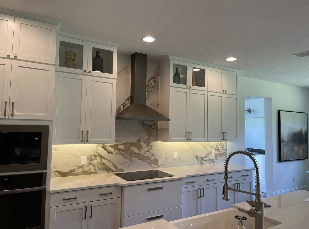 White shaker cabinet kitchen with marble backsplash, Line Flooring project