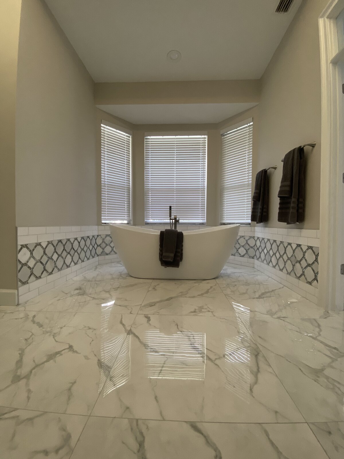 Large-format tile flooring in a bathroom remodel