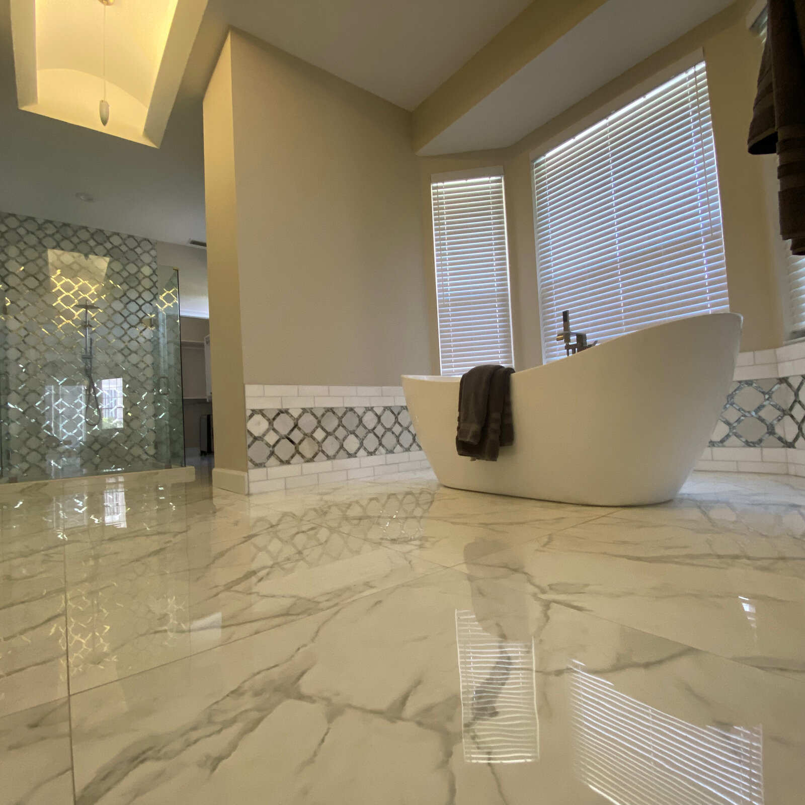Marble tile bathroom floor with freestanding tub, alternate angle
