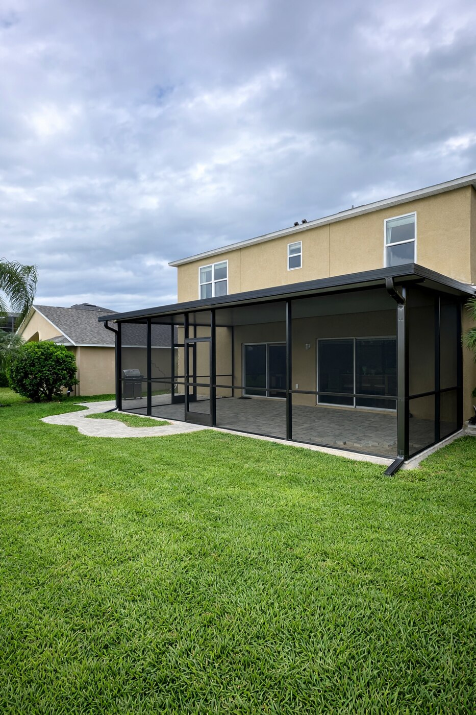 Aluminum screen room enclosure over a paver patio